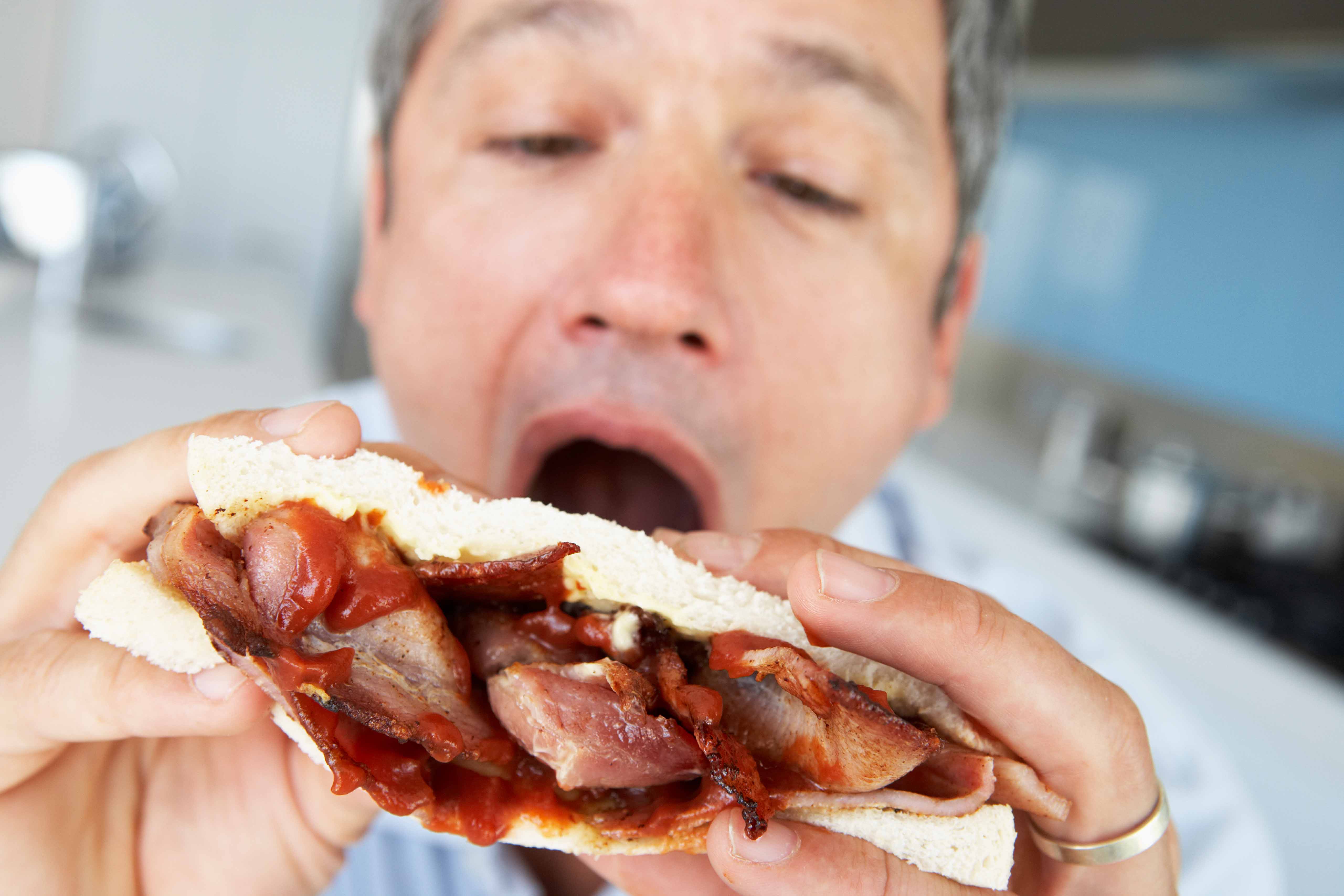 Middle Aged Man Eating A Bacon Sandwich National Club Golfer