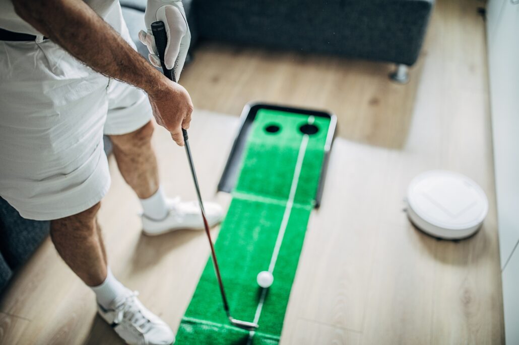 Man practicing putting at home